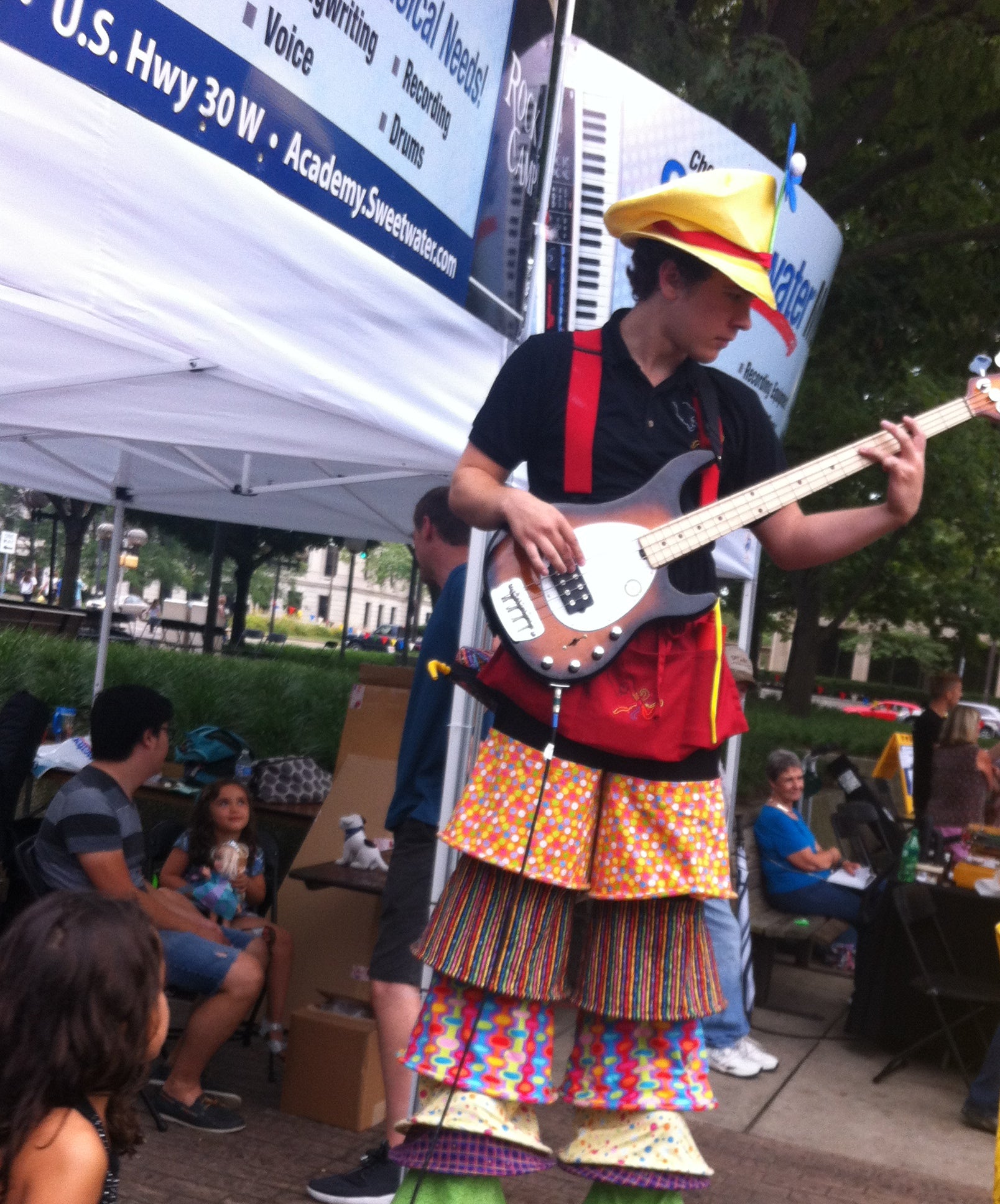 bass playing stilt walker