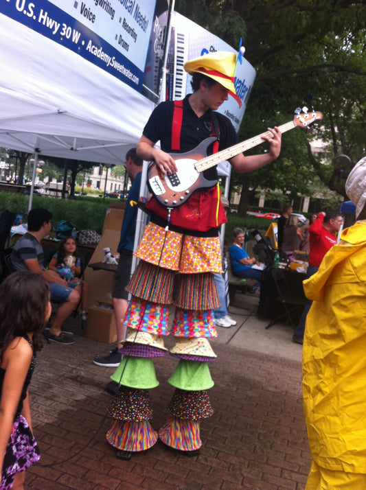 bass playing stilt walker